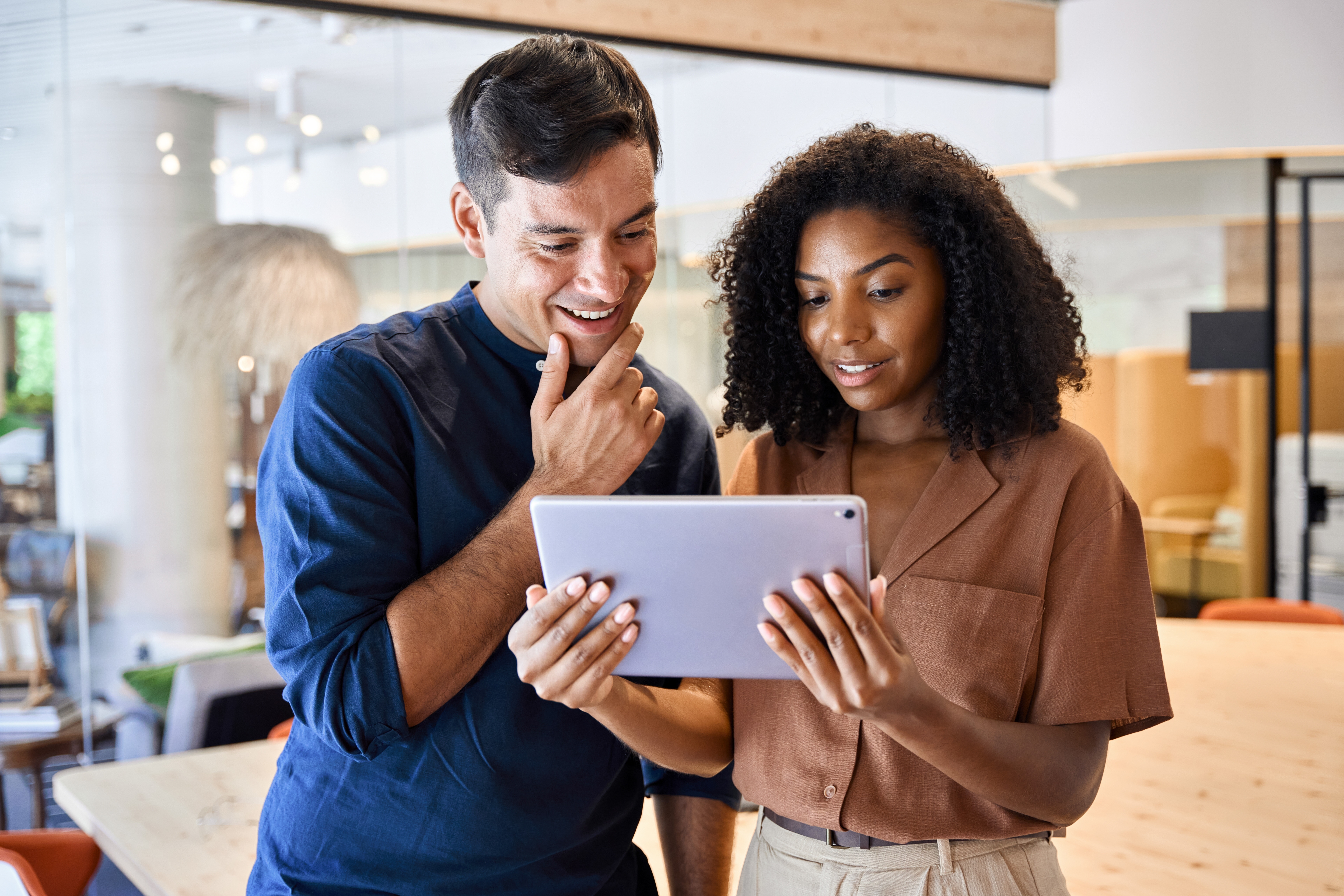 Two workers looking at a laptop